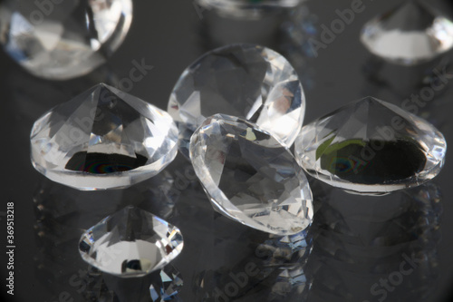 Precious expensive stones lie on black background. Sale of diamonds and polished diamonds creation of jewelry concept