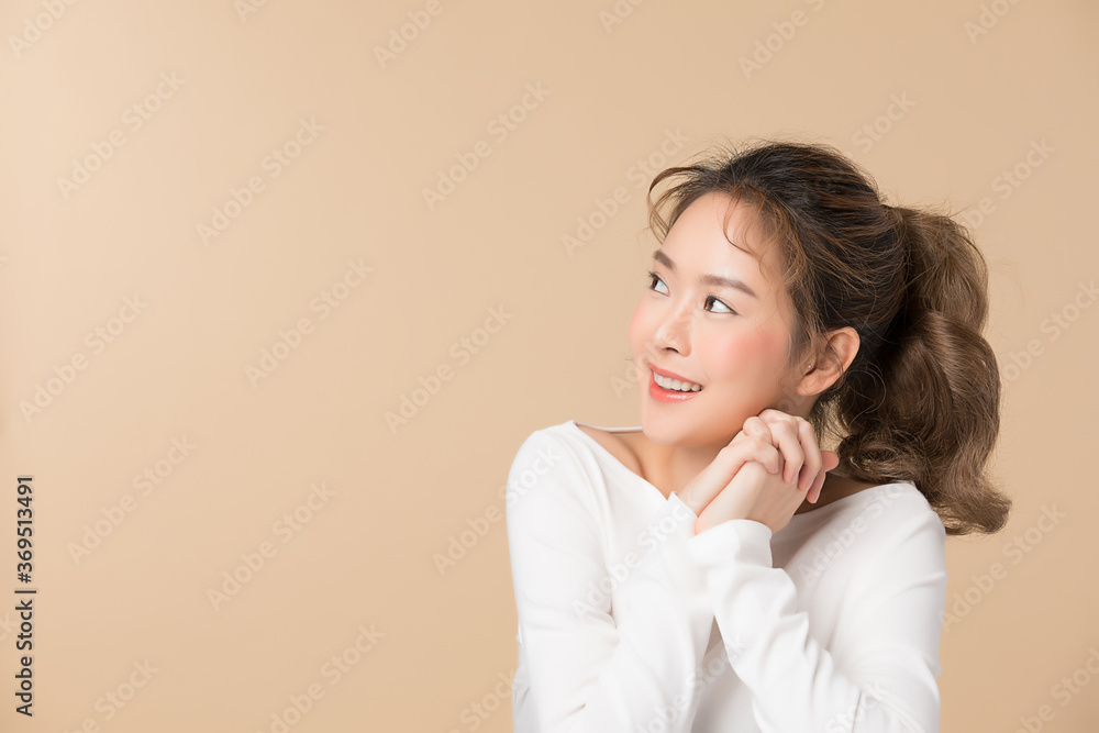 portrait of a young woman posing gesture isolated on brown color background portrait of a young woman posing gesture isolated on brown color background