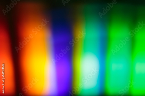 Visible spectrum of light: a prism disperses a beam of white light and wavelengths in the form of colors visible to the human eye are separated and projected onto a screen