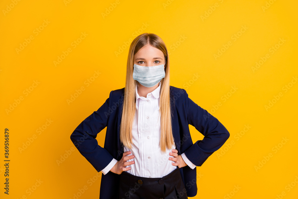 Portrait of her she nice attractive content healthy long-haired schoolkid wearing safety gauze mask hands on hips mers cov prevention isolated bright vivid shine vibrant yellow color background Portrait of her she nice attractive content healthy long-haired schoolkid wearing safety gauze mask hands on hips mers cov prevention isolated bright vivid shine vibrant yellow color background