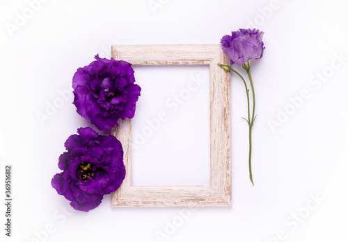 Photo frame with purple flowers on white background