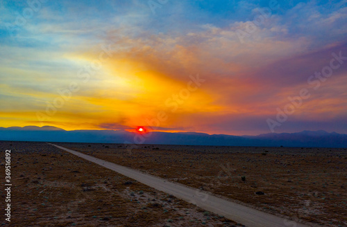 fiery sunset over the road in the mojave desert