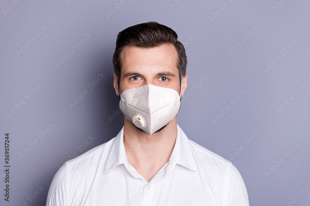 Close-up portrait of his he attractive healthy guy wearing safety mask stop respiratory disease contamination infection influenza medicine flu flue isolated over gray color background Close-up portrait of his he attractive healthy guy wearing safety mask stop respiratory disease contamination infection influenza medicine flu flue isolated over gray color background