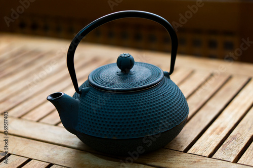 Japanese-style kettle for making tea. Old style wooden background