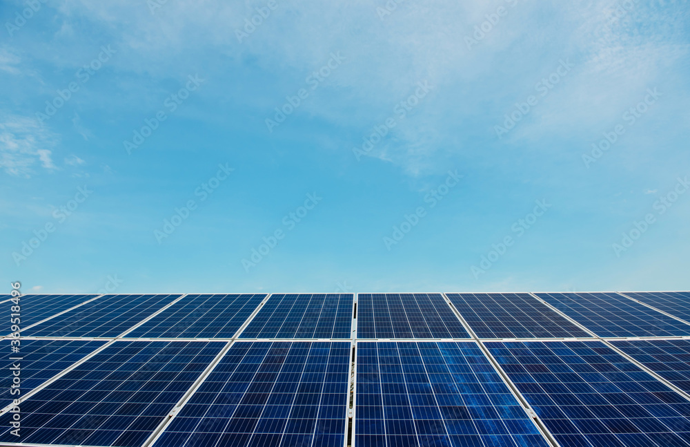 Photovoltaic power plant. Solar photovoltaic panels on blue sky background Photovoltaic power plant. Solar photovoltaic panels on blue sky background