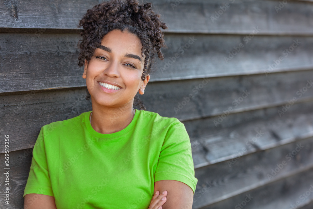 Fototapeta premium Girl teenager teen female young African American woman outside smiling with perfect teeth
