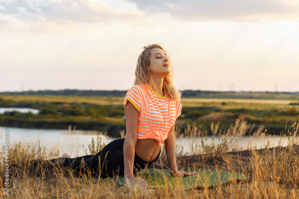 Young blonde woman making yoga outdoors. Young blonde woman making yoga outdoors.