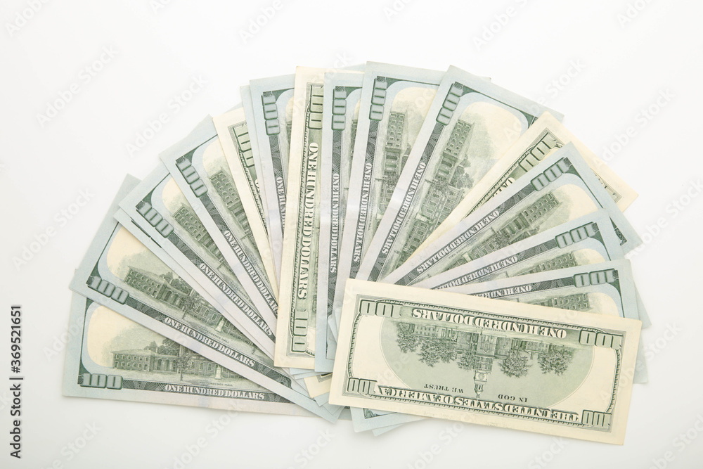A pile of hundred dollar bills on white background with copy space A pile of hundred dollar bills on white background with copy space