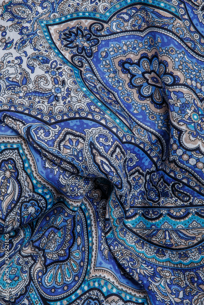 top view closeup on crumpled blue cotton scarf with oriental paisley ornament