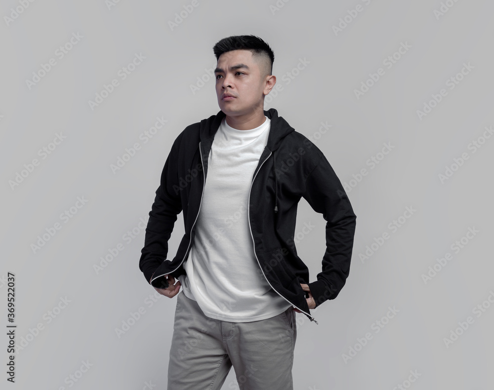 Young handsome man wearing black hoodie and white t shirt isolated on background Young handsome man wearing black hoodie and white t shirt isolated on background