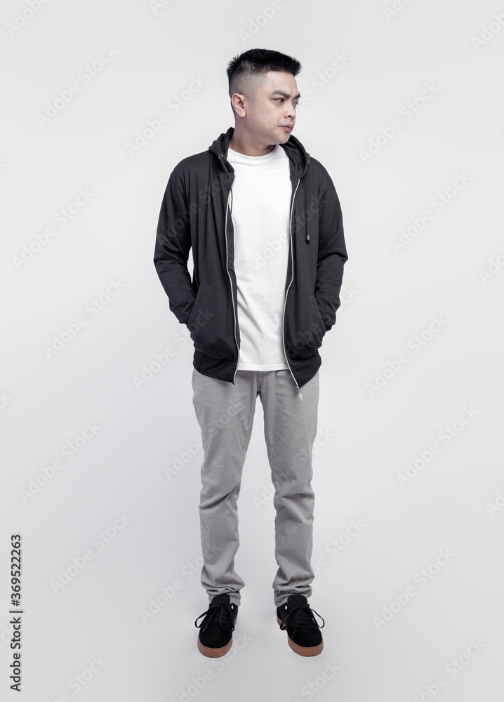 Young handsome man wearing black hoodie and white t shirt isolated on background Young handsome man wearing black hoodie and white t shirt isolated on background