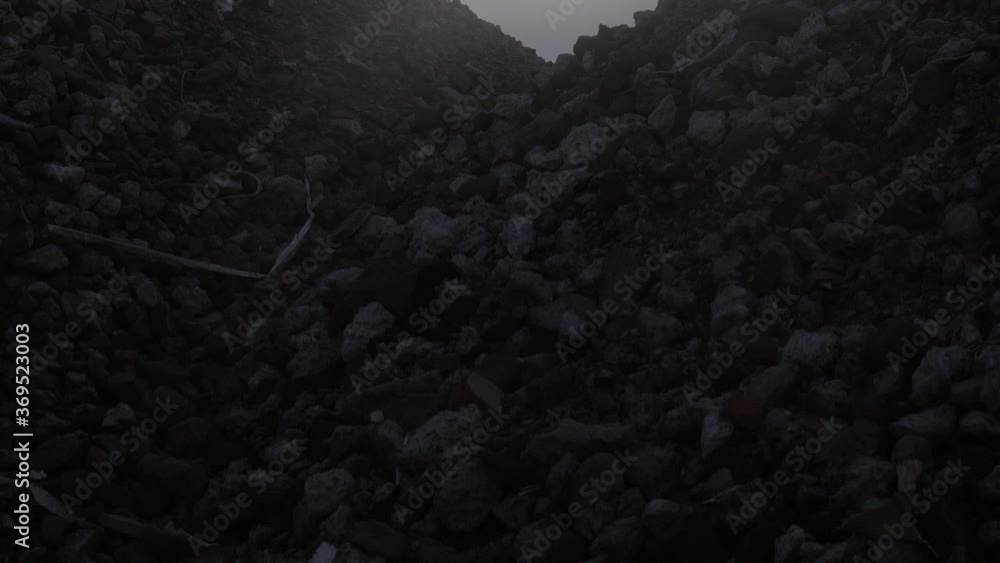 Pan up from rubble to a sunset, various types of remnants from a ...
