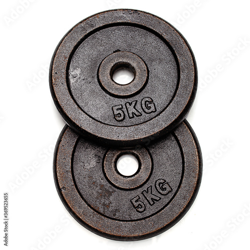 top view on two 5 kg weight disks isolated on white background. bodybuilding equipment