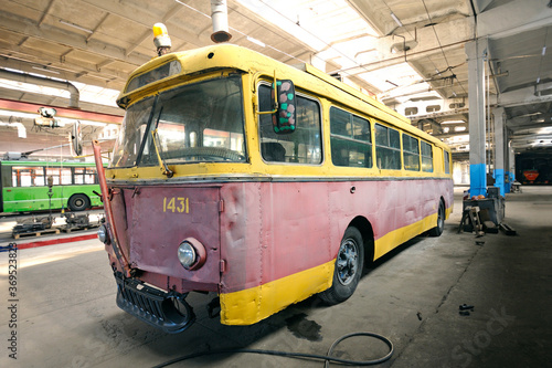Old but still working trolleybus parked at the trolley depot hangar for technical inspection
