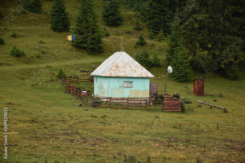 Old house with flag in Romanian mountains