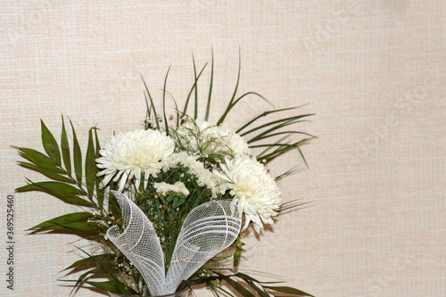 bouquet of white chrysanthemums on a light background, copy space