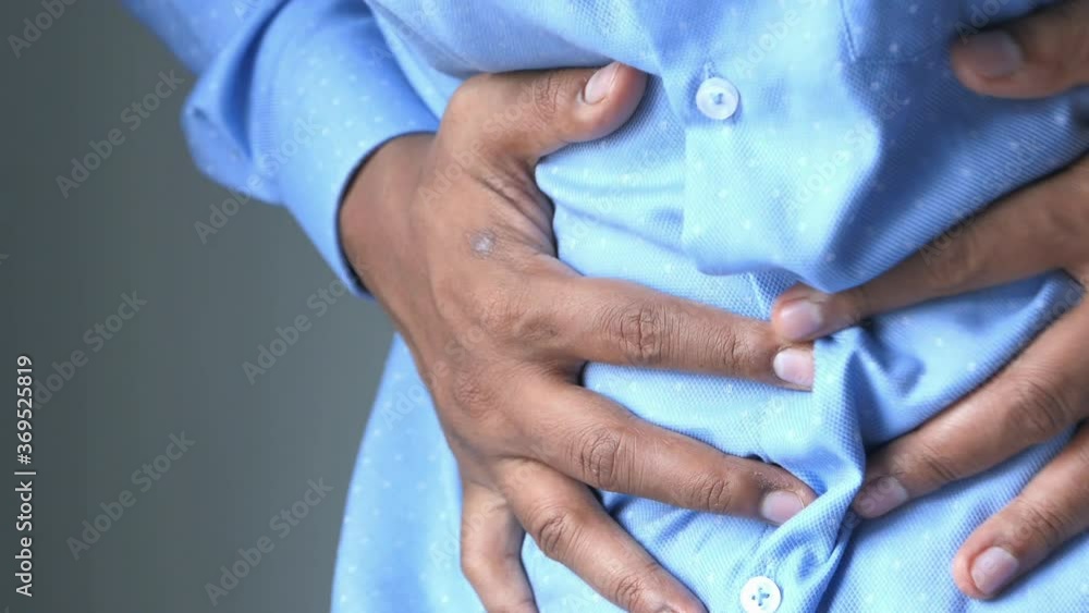 young man suffering stomach pain close up. young man suffering stomach pain close up.