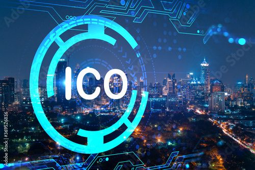 Initial coin offering hologram, night panorama city view of Bangkok, the center of cryptocurrency projects in Asia. The concept of widespread ICO hysteria. Double exposure.