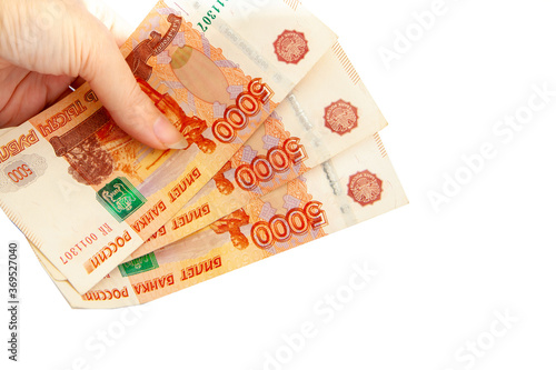 Fifteen thousand Russian rubles in hand on a white background