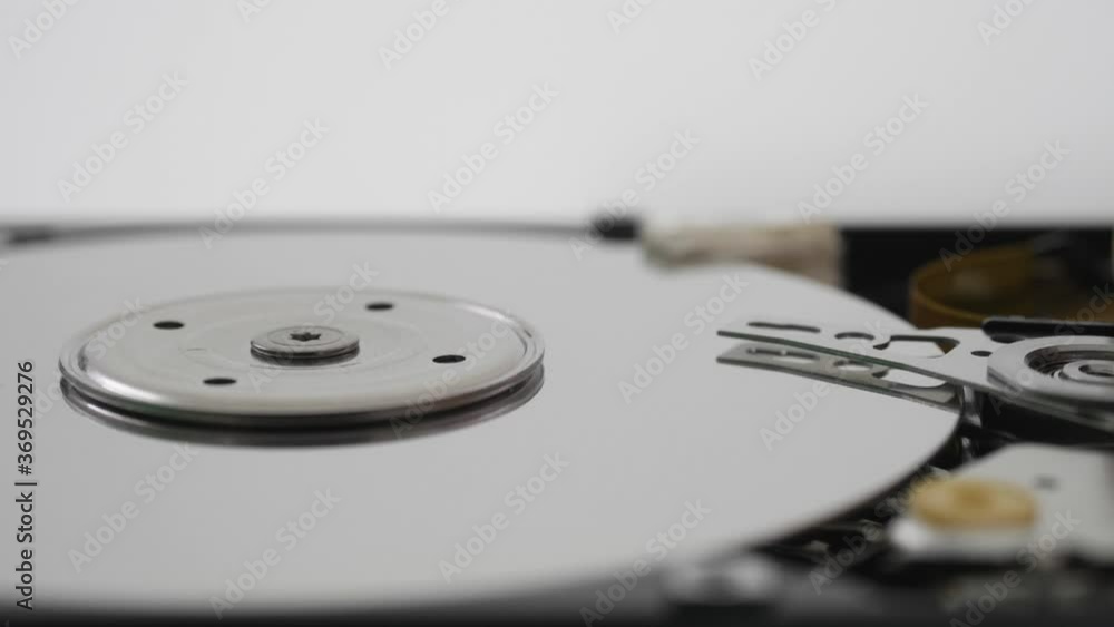 Detail of driving arm with optical laser moves to read data on hard disk plate Detail of driving arm with optical laser moves to read data on hard disk plate