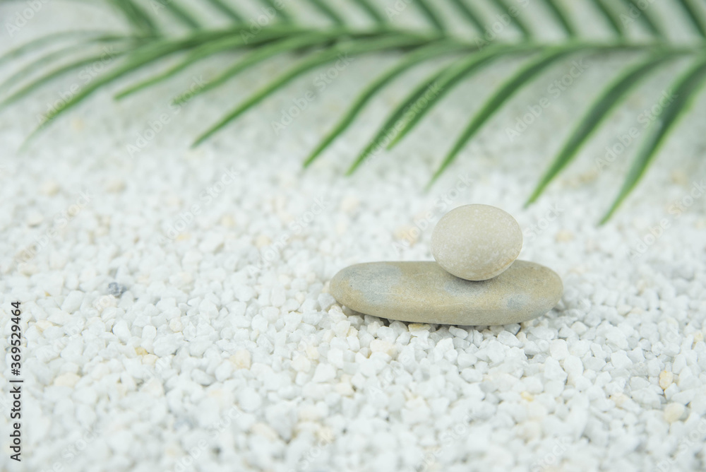 Pyramids of gray and white zen pebble meditation stones on white background. Concept of harmony, balance and meditation, spa, massage, relax Pyramids of gray and white zen pebble meditation stones on white background. Concept of harmony, balance and meditation, spa, massage, relax
