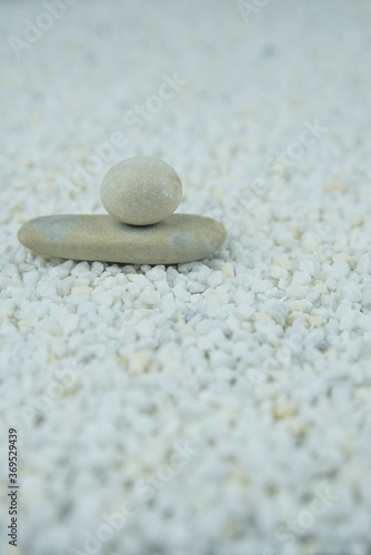 Pyramids of gray and white zen pebble meditation stones on white background. Concept of harmony, balance and meditation, spa, massage, relax