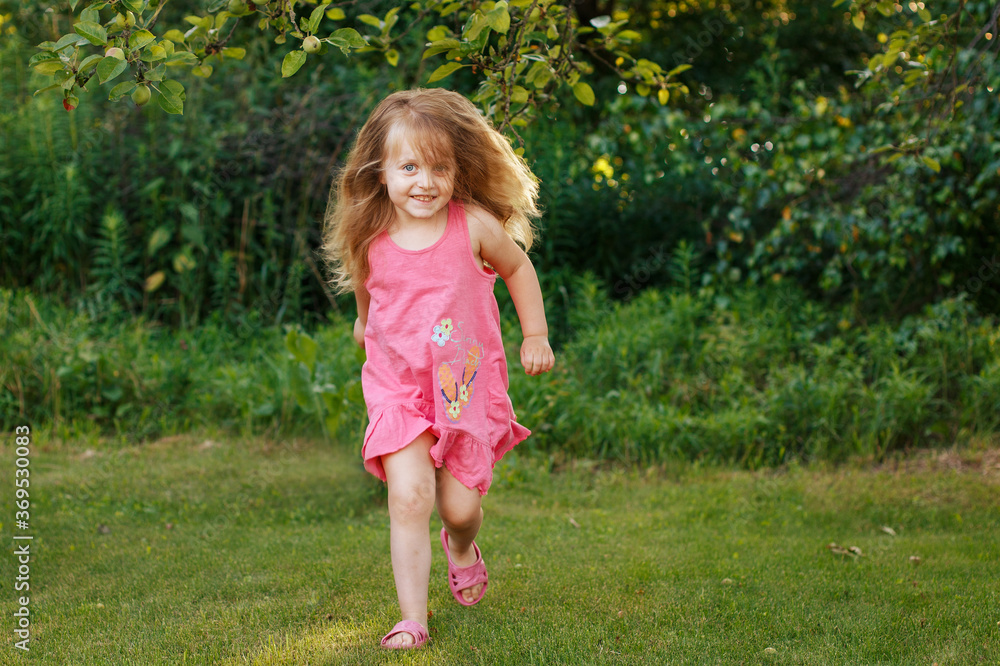 happy baby smiling. little girl running at a sunset outdoor happy baby smiling. little girl running at a sunset outdoor