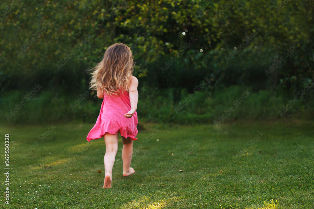 happy baby smiling. little girl running at a sunset outdoor happy baby smiling. little girl running at a sunset outdoor