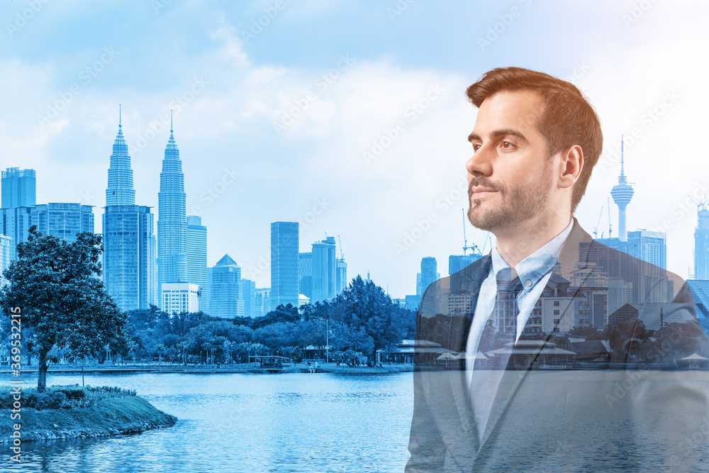 Young handsome businessman in suit thinking how to succeed, new career opportunities, MBA. Kuala Lumpur on background. Double exposure. Young handsome businessman in suit thinking how to succeed, new career opportunities, MBA. Kuala Lumpur on background. Double exposure.