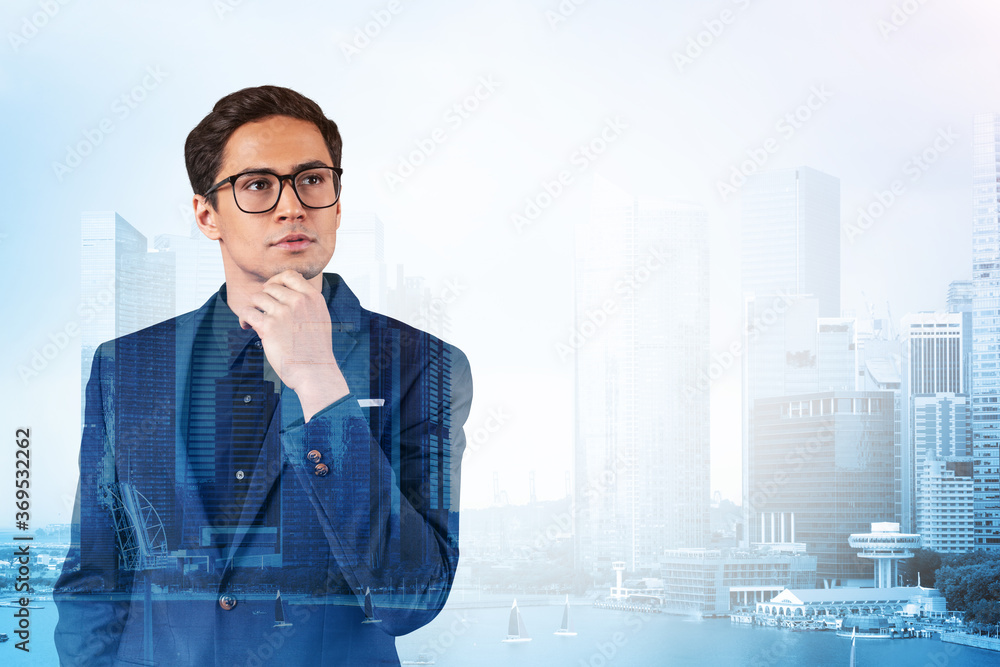 Young handsome businessman in suit and glasses dreaming about new career opportunities after MBA graduation. Singapore on background. Double exposure. Young handsome businessman in suit and glasses dreaming about new career opportunities after MBA graduation. Singapore on background. Double exposure.