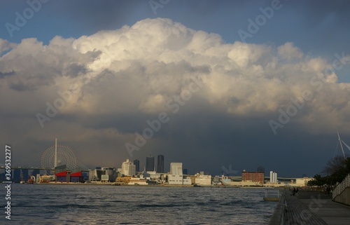  landscape of Tempozan Harbor Village with ferris wheel ,bridge and aquarium with big rainny cloud osaka japan