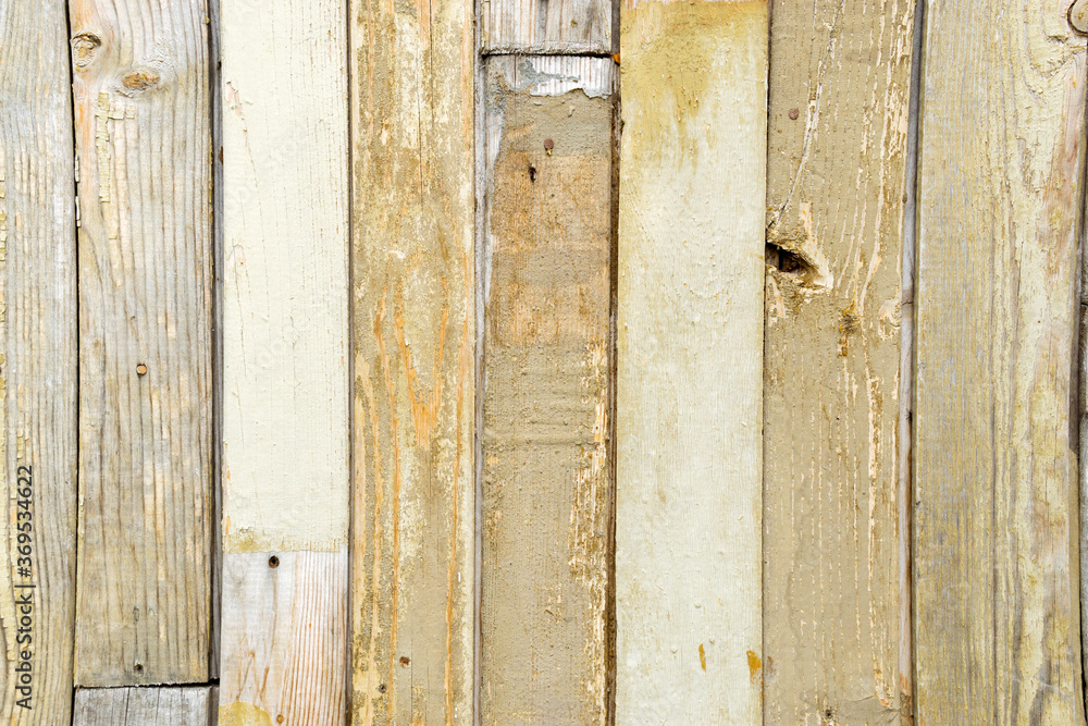 old retro texture of wooden yellow fence old paint with nails. background