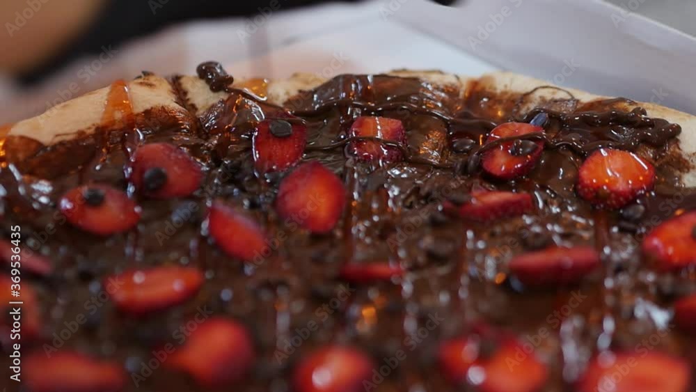 Drizzling Chocolate Sauce Atop Of A Homemade Chocolate And Strawberries Pizza Dessert Drizzling Chocolate Sauce Atop Of A Homemade Chocolate And Strawberries Pizza Dessert
