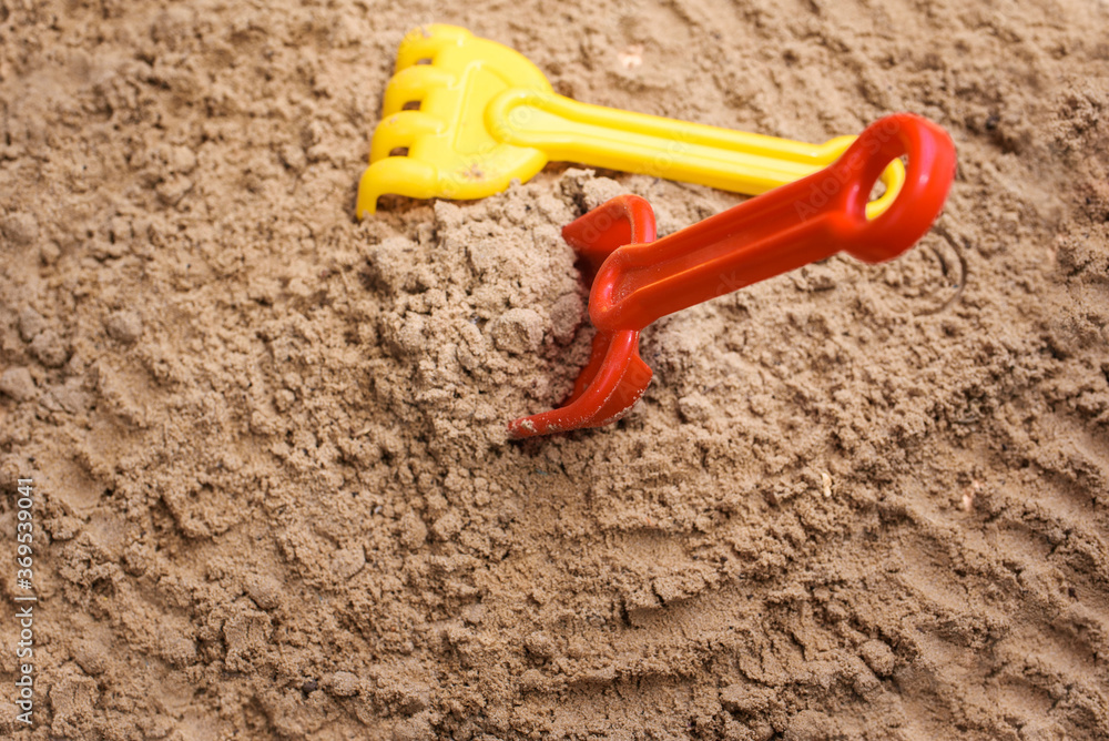 Beach sand with toys for the baby, water, the word summer in colored letters. Staycation content Beach sand with toys for the baby, water, the word summer in colored letters. Staycation content