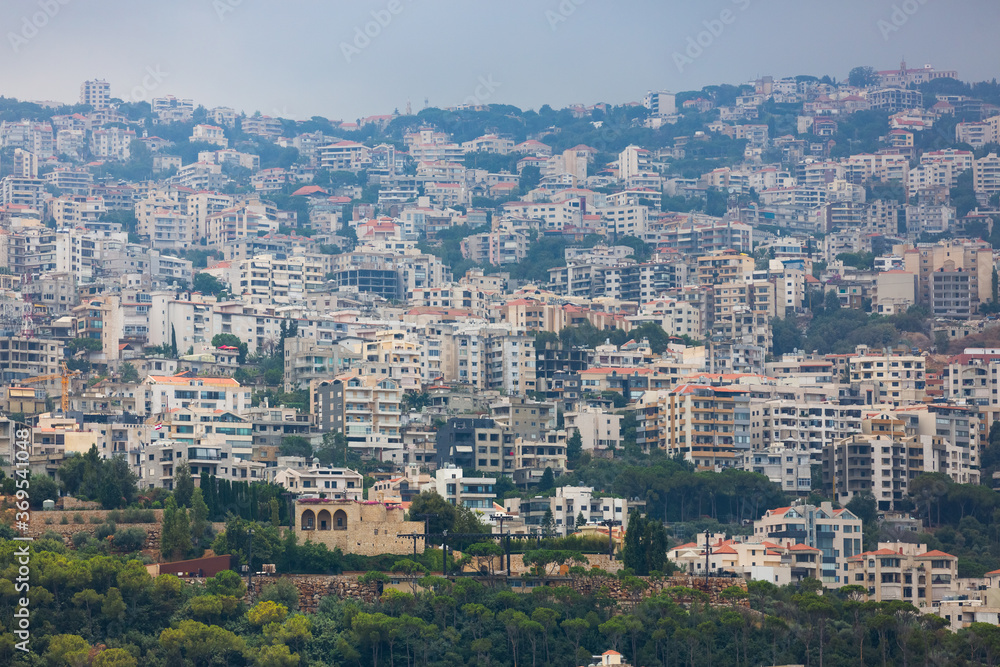 Obraz premium Dense development of Lebanese towns. Hills covered with a lot of houses. Panoramic view of villages in Lebanon