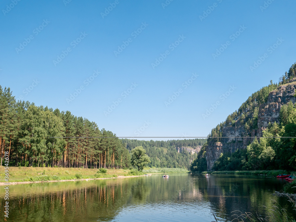 Landscape, river, mountains, forests on a summer day. Rafting down the river on rafts. Landscape, river, mountains, forests on a summer day. Rafting down the river on rafts.
