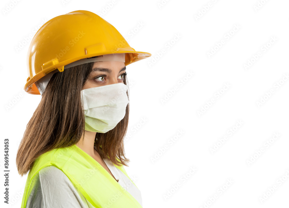 Amused young woman in yellow hardhat, green reflective vest and lumberjack shirt Amused young woman in yellow hardhat, green reflective vest and lumberjack shirt