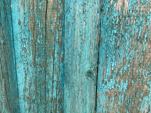 light blue wooden house wall with peeling old paint, texture