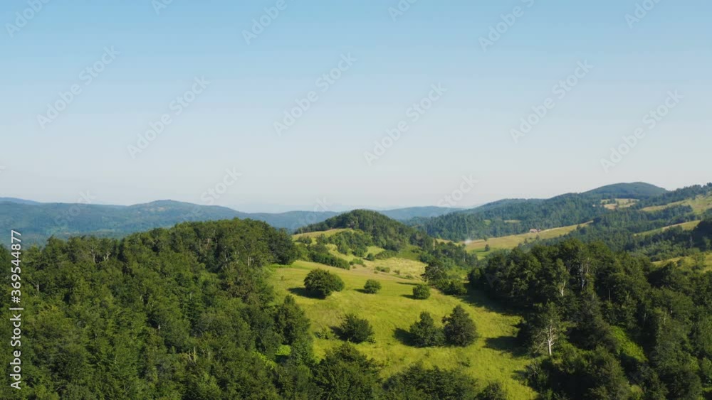 beautiful forest and meadows on top of the hill -nature scenery of mountains in summer- drone aerial moving to the left beautiful forest and meadows on top of the hill -nature scenery of mountains in summer- drone aerial moving to the left
