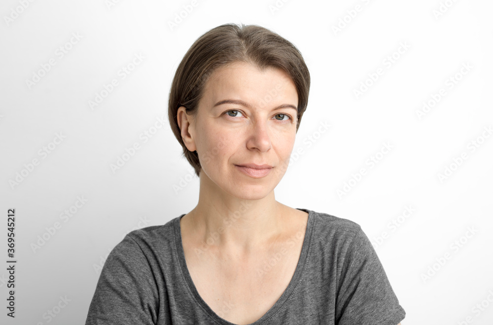 Portrait of an attractive woman on a white background. Pretty smiling middle-aged woman. Portrait of an attractive woman on a white background. Pretty smiling middle-aged woman.