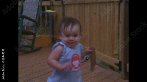 Super 8 retro / vintage footage of toddler learning to walk on front porch
