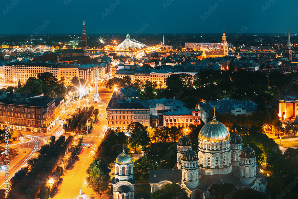 Riga, Latvia. Evening Night Aerial View Cityscape, Landmarks St. Peter's Church, Boulevard Of Freedom, Freedom Monument, National Library, Dome Cathedral, Nativity Of Christ Cathedral.