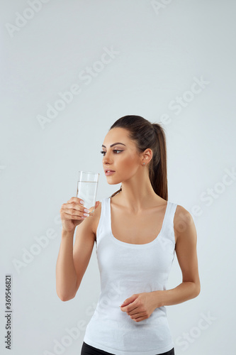 Portrait Of Happy Smiling Young Woman With Glass Of Fresh Water. Healthcare. Drinks. Health, Beauty, Diet Concept. Healthy Lifestyle Eating.
