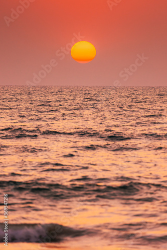 Fototapeta Naklejka Na Ścianę i Meble -  Natural Color Sunset Sunrise Sky Over Sea. Seascape With Shining Setting Sun On Sea Horizon