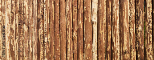 Quadro su tela Wooden surface for natural background. Fence made of tree trunks.