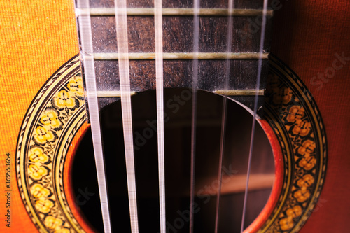 фотографія Close-up of acoustic guitar with vibrating strings