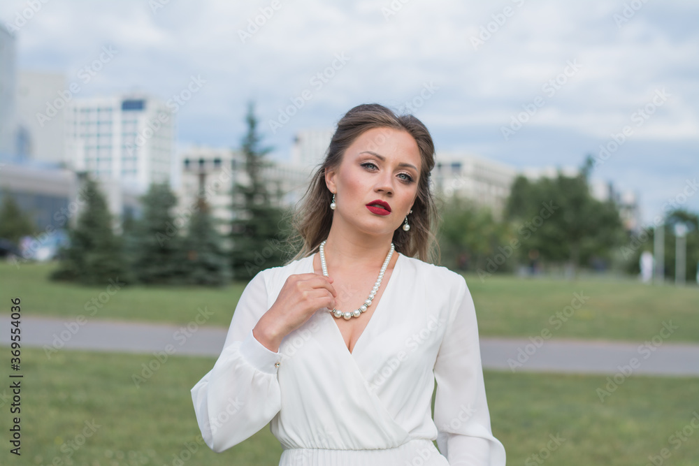 Gorgeous young model woman with perfect blonde hair looking at camera posing in the city Gorgeous young model woman with perfect blonde hair looking at camera posing in the city