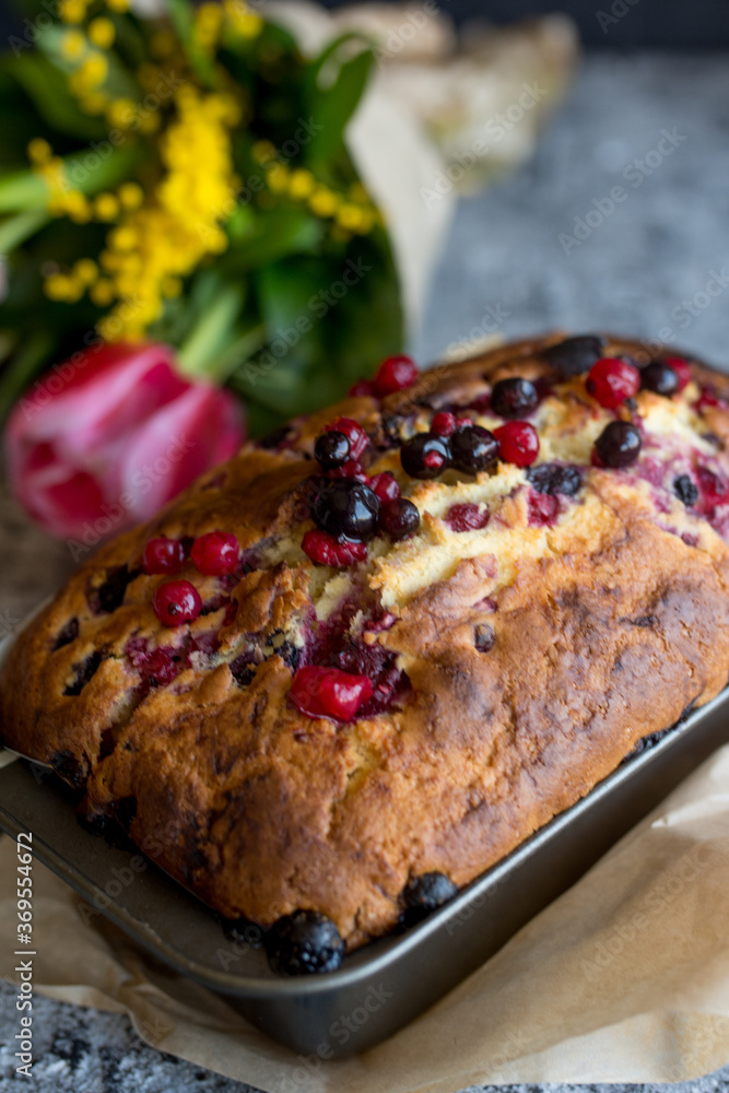Loaf cake with red berries on the table