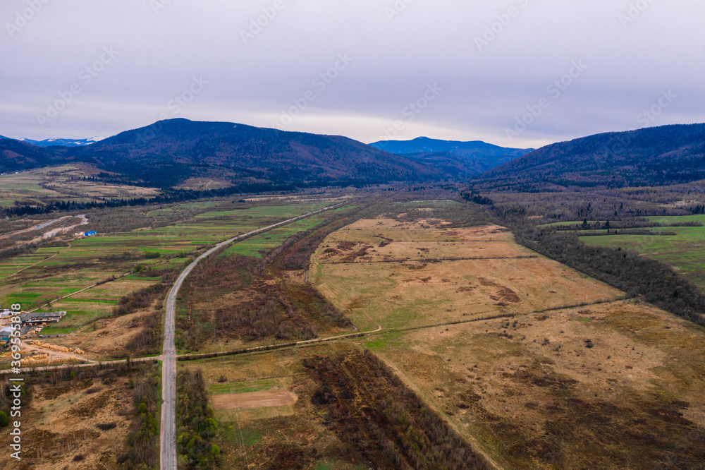 Top view of the village and Ukrainian off-road, villages of the Ukrainian Carpathians, highway without cars.