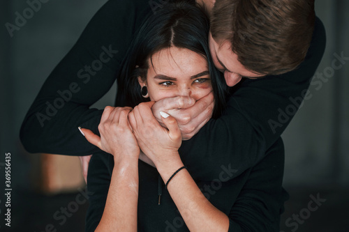Slika na platnu Man's hand covering her mouth